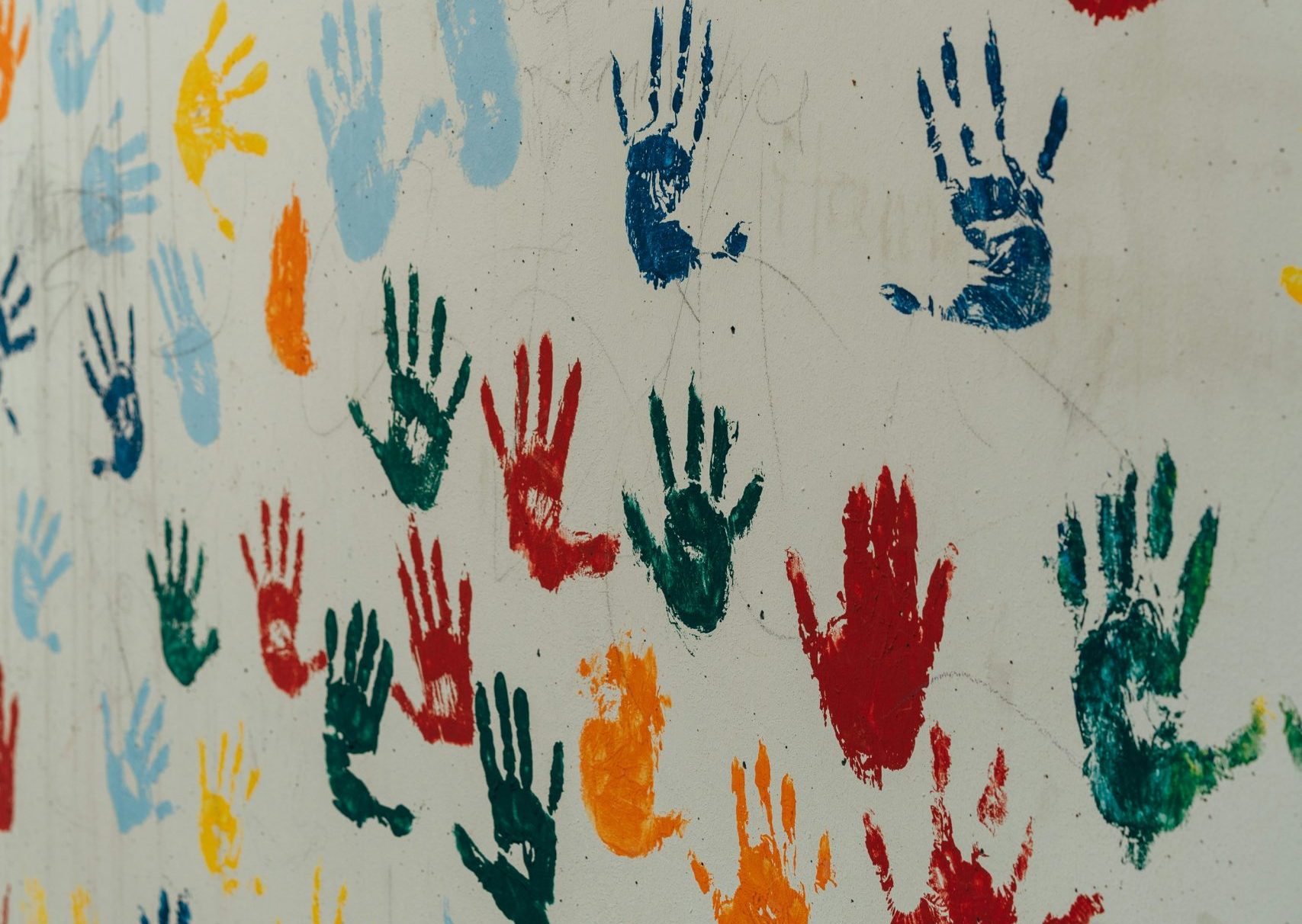 childrens hands painted in a wall